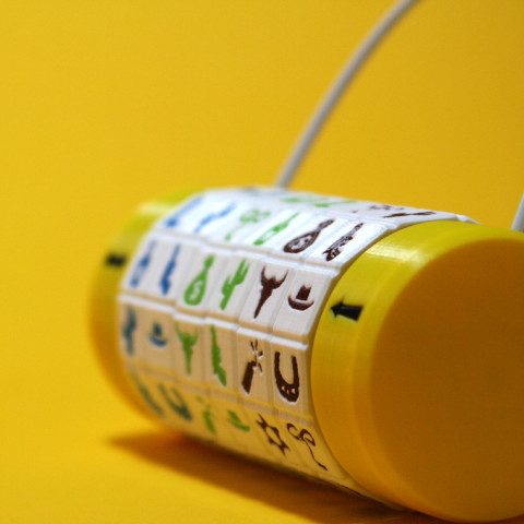 A custom-made padlock with yellow dials and red letter symbols.